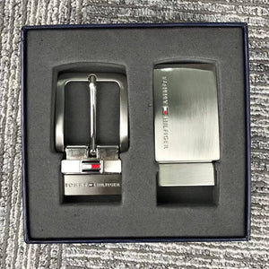 Close up of two interchangeable Tommy Hilfiger belt buckles: Metal Plaque and Classic Prong