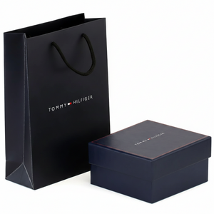 Luxury Tommy Hilfiger men's accessory gift packaging featuring a navy blue branded box with red stitching and a matching premium shopping bag
