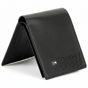 Side angle view of Tommy Hilfiger black leather wallet highlighting vertical embossed branding and flag logo