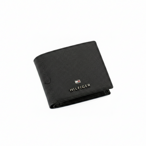 Perspective view of a partially open Tommy Hilfiger men's black genuine leather bifold wallet, highlighting the smooth texture and metal flag logo.