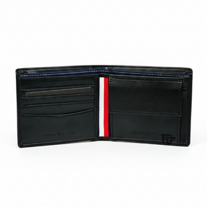 Interior layout of Tommy Hilfiger black wallet showing snap button coin pocket, card slots, and signature tricolor stripe lining