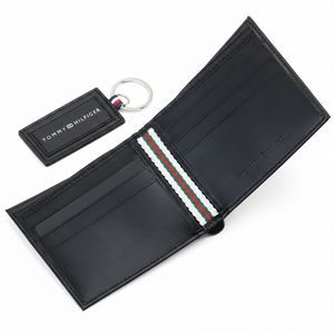 Fully open interior view of a Tommy Hilfiger men's black leather wallet displaying multiple card slots, debossed branding, and a signature striped fabric detail along the center fold