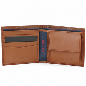 Detailed interior of the Tommy Hilfiger brown leather wallet showing organized card slots, a secure buttoned coin pocket, and a stylish navy blue patterned lining