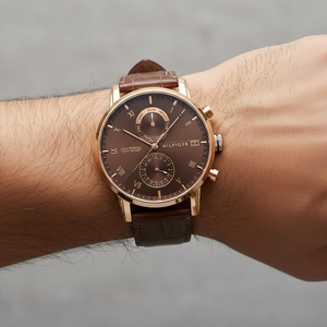 Close up of brown sunray dial and rose gold-tone Roman numerals of Tommy Hilfiger 1710400