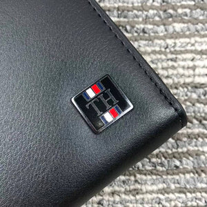 Close up detail of Square TH Metal and Enamel Logo on black leather wallet
