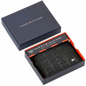 Authentic Tommy Hilfiger men's brown genuine leather bifold wallet featuring a signature branding stripe and metal logo, presented in its luxury navy gift box