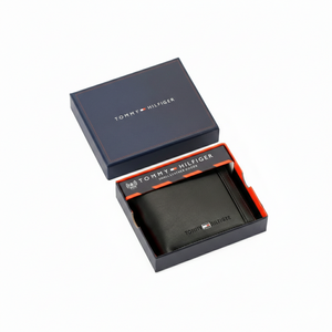 Authentic Tommy Hilfiger men's black genuine leather bifold wallet with vertical branding detail, presented in a premium navy branded gift box