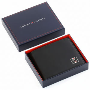 Authentic Tommy Hilfiger men's black Saffiano leather bifold wallet with enamel flag logo, presented in a premium navy branded gift box