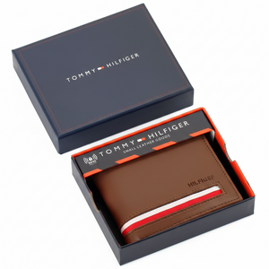 Authentic Tommy Hilfiger men's brown genuine leather bifold wallet with horizontal branding stripe, displayed in its premium navy branded gift box