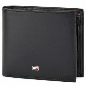 Close-up angled shot of the Tommy Hilfiger black leather wallet showcasing the high-quality embossed branding pattern and silver metal logo