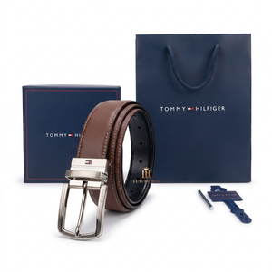 Tommy Hilfiger brown belt with silver buckle, packaging, and keychain on a white background