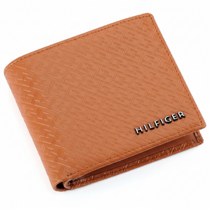 Perspective view of a Tommy Hilfiger tan genuine leather bifold wallet showcasing the textured Hilfiger logo pattern and premium finish