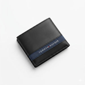 Professional angled studio photograph of the sleek Tommy Hilfiger mirror original smooth black leather bifold wallet