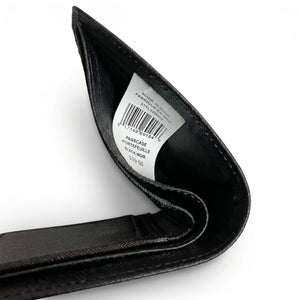 Live high-angle view of the Tommy Hilfiger smooth leather wallet currency compartment displaying the navy fabric lining and original tracking barcode label