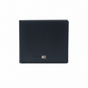 Front view of Tommy Hilfiger navy blue smooth leather wallet featuring centered horizontal text and flag logo