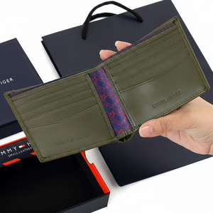 Interior view of a Tommy Hilfiger olive green leather bifold wallet showing multiple card slots and premium branded lining