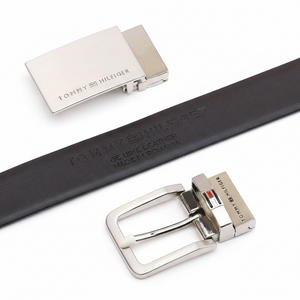Tommy Hilfiger men's reversible leather belt set showcasing the rich brown side with an embossed brand logo and two interchangeable silver metal buckles