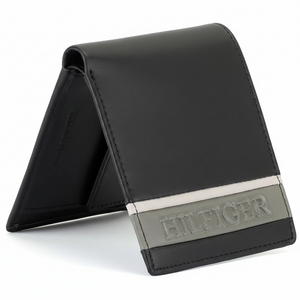 Side view of a standing Tommy Hilfiger tan genuine leather bifold wallet showcasing its sleek profile and contrasting color design