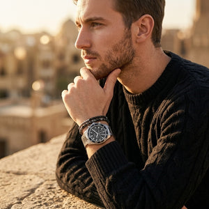 Elegant man wearing Guess Chaser W0170G1 men's quartz battery watch with silver case and luxury silver metal bracelet
