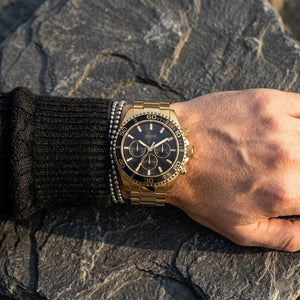 Close up of Guess Chaser W0170G2 men's quartz battery watch on wrist showing clean black dial and luxury black dive bezel