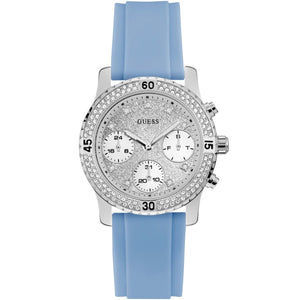 Guess Confetti W1098L3 women's quartz battery watch with cushion-shaped silver-tone case textured dynamic bezel embellished with crystals and screw details deep silver-white dial with luminous silver hands and indices and integrated flexible light blue silicone rubber strap main view
