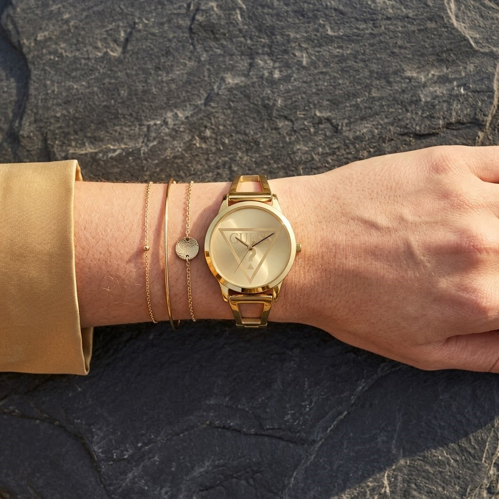 Close up of Guess W1145L3 women's quartz battery watch on wrist showing iconic triangle question mark logo dial