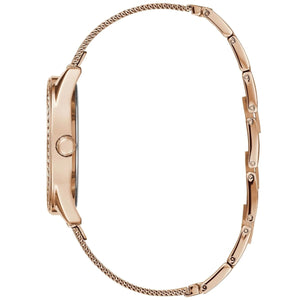 Left angled view of Guess Claudia W1279L3 women's quartz battery watch showing printed rose gold mesh strap and sleek case profile