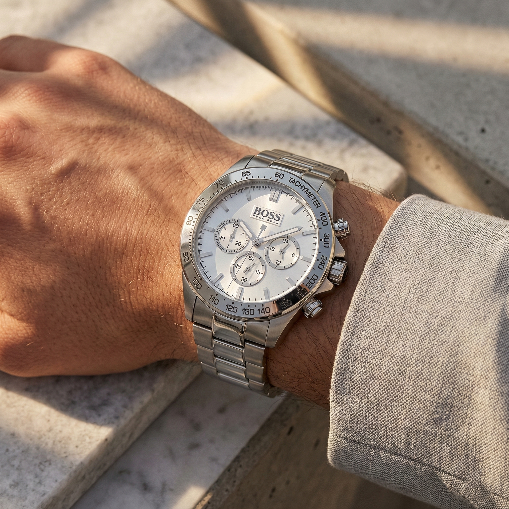 Close up of Hugo Boss Ikon 1512962 on wrist showing silver dial and silver metal strap with 100m water resistance