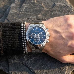 Close up of Hugo Boss Ikon 1512963 men's quartz battery watch on wrist showing blue dial and luxury silver markers