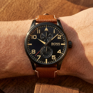 Close up of Hugo Boss Aeroliner Maxx 1513082 on wrist showing black dial and tan leather strap with 50m water resistance