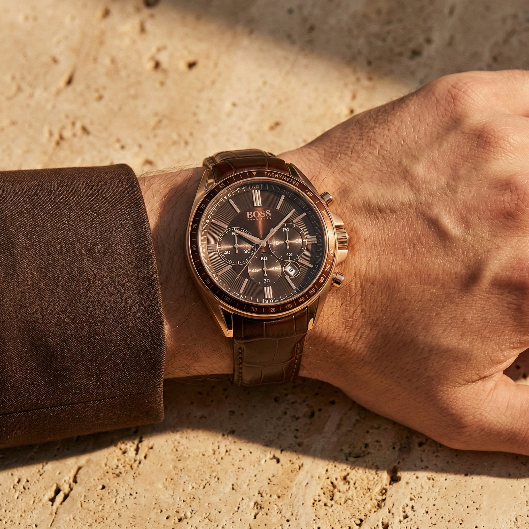 Close up of Hugo Boss Driver Runner 1513093 on wrist showing brown dial and rose gold case with 50m water resistance