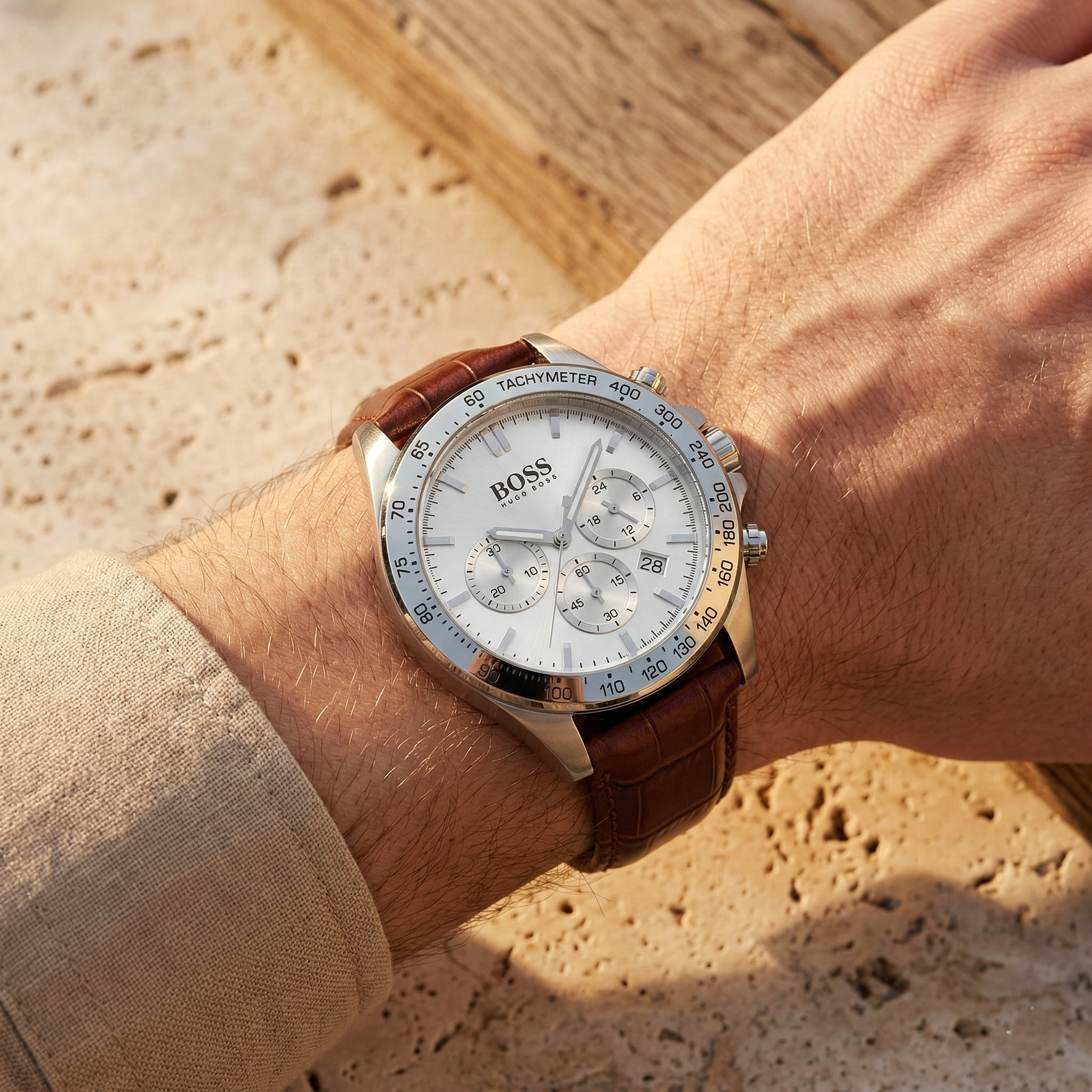 Close up of Hugo Boss Ikon 1513175 on wrist showing white dial and brown leather strap with 100m water resistance