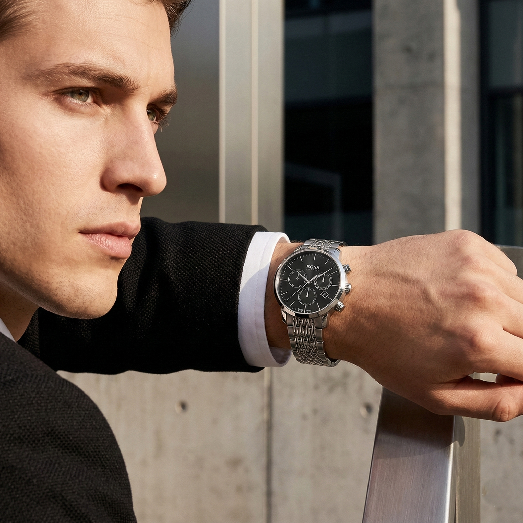 Professional man wearing Hugo Boss Signature 1513267 with black dial and silver metal link strap water resistant 50m