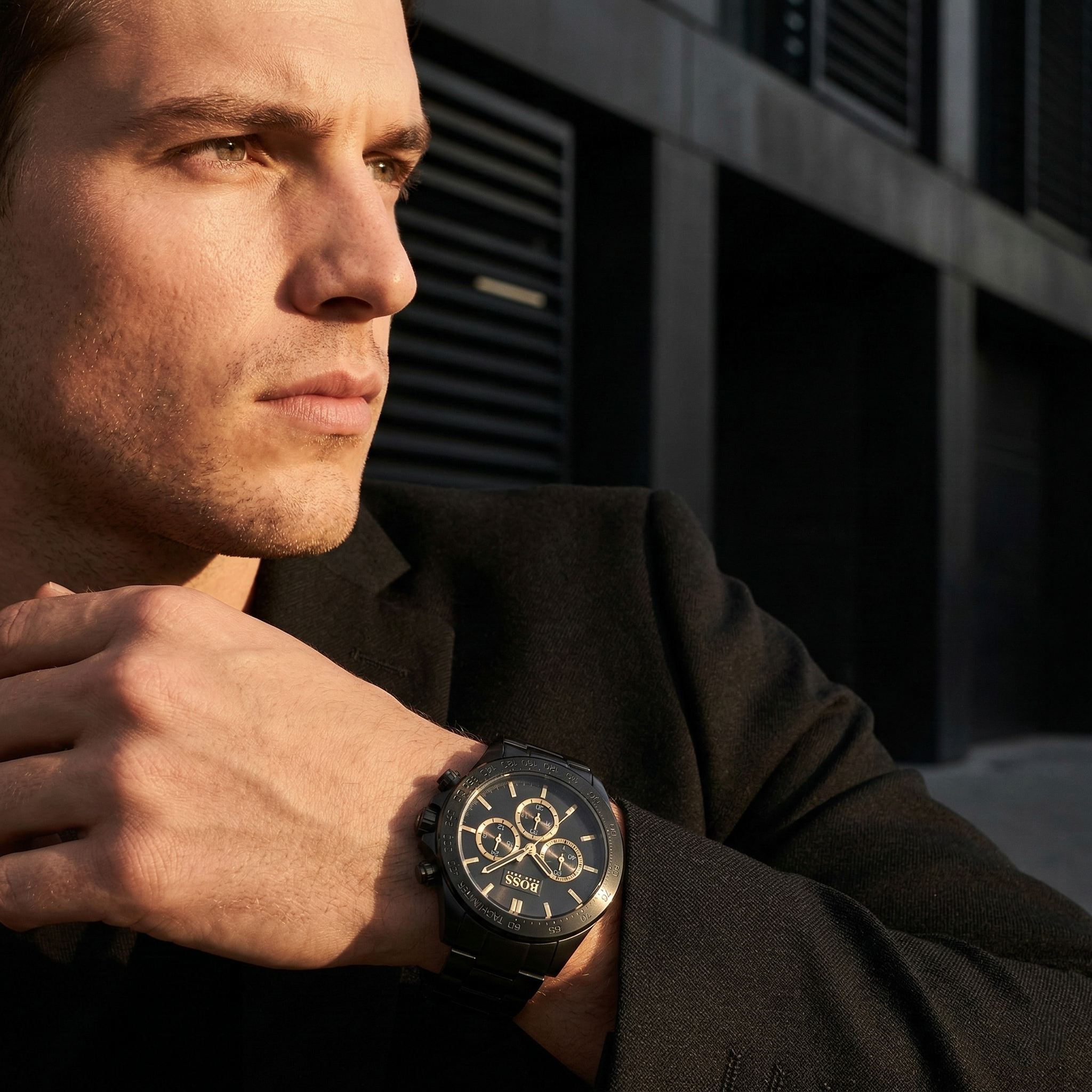 Professional man wearing Hugo Boss Ikon 1513278 with black dial and black metal link strap water resistant 100m