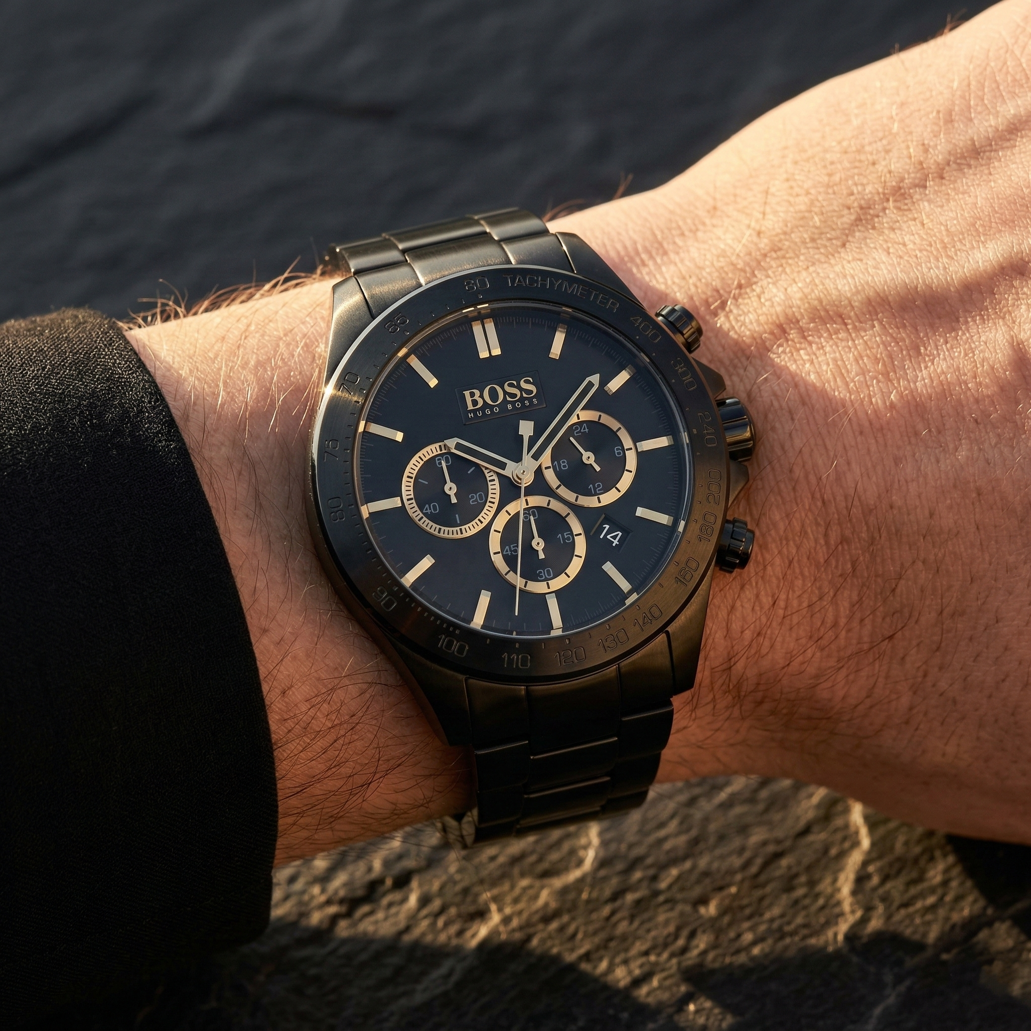 Close up of Hugo Boss Ikon 1513278 on wrist showing black dial and black metal strap with 100m water resistance