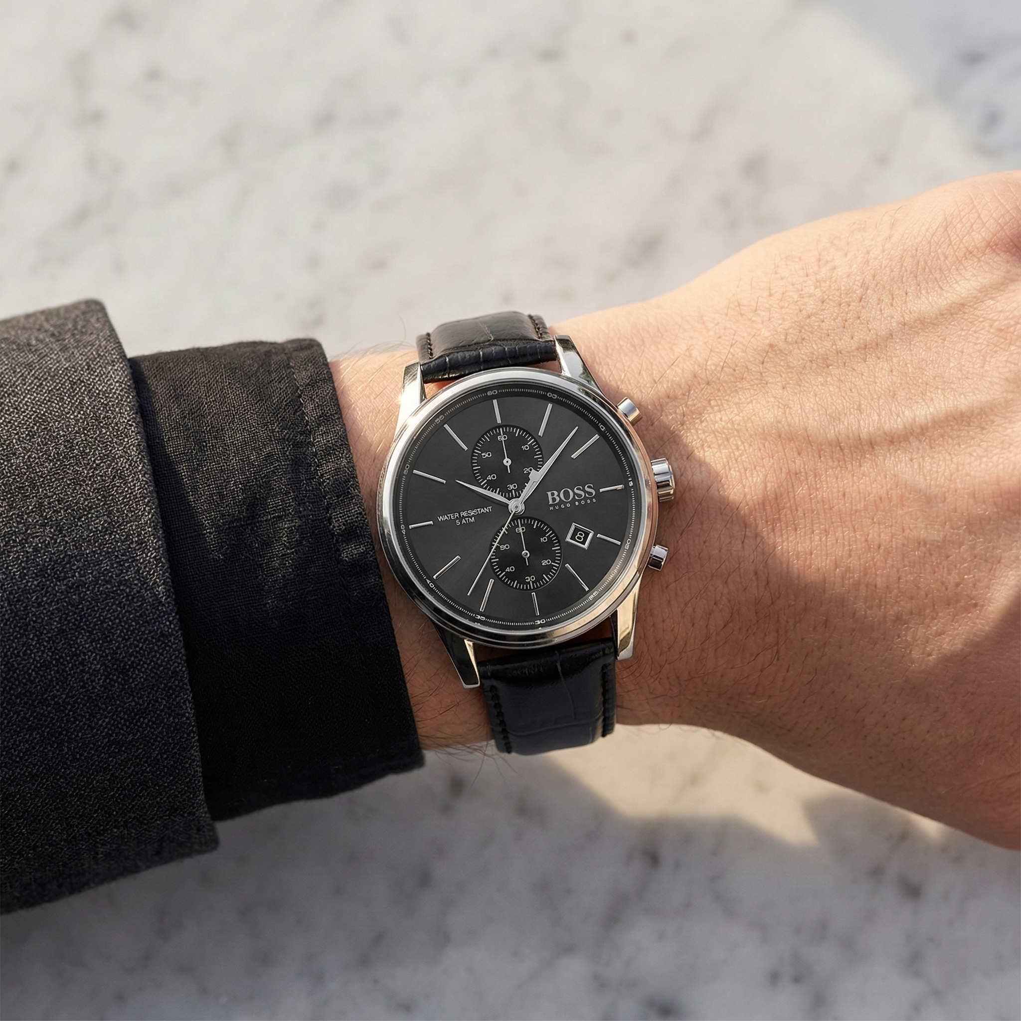 Close up of Hugo Boss Jet 1513279 on wrist showing black dial and black leather strap with 50m water resistance