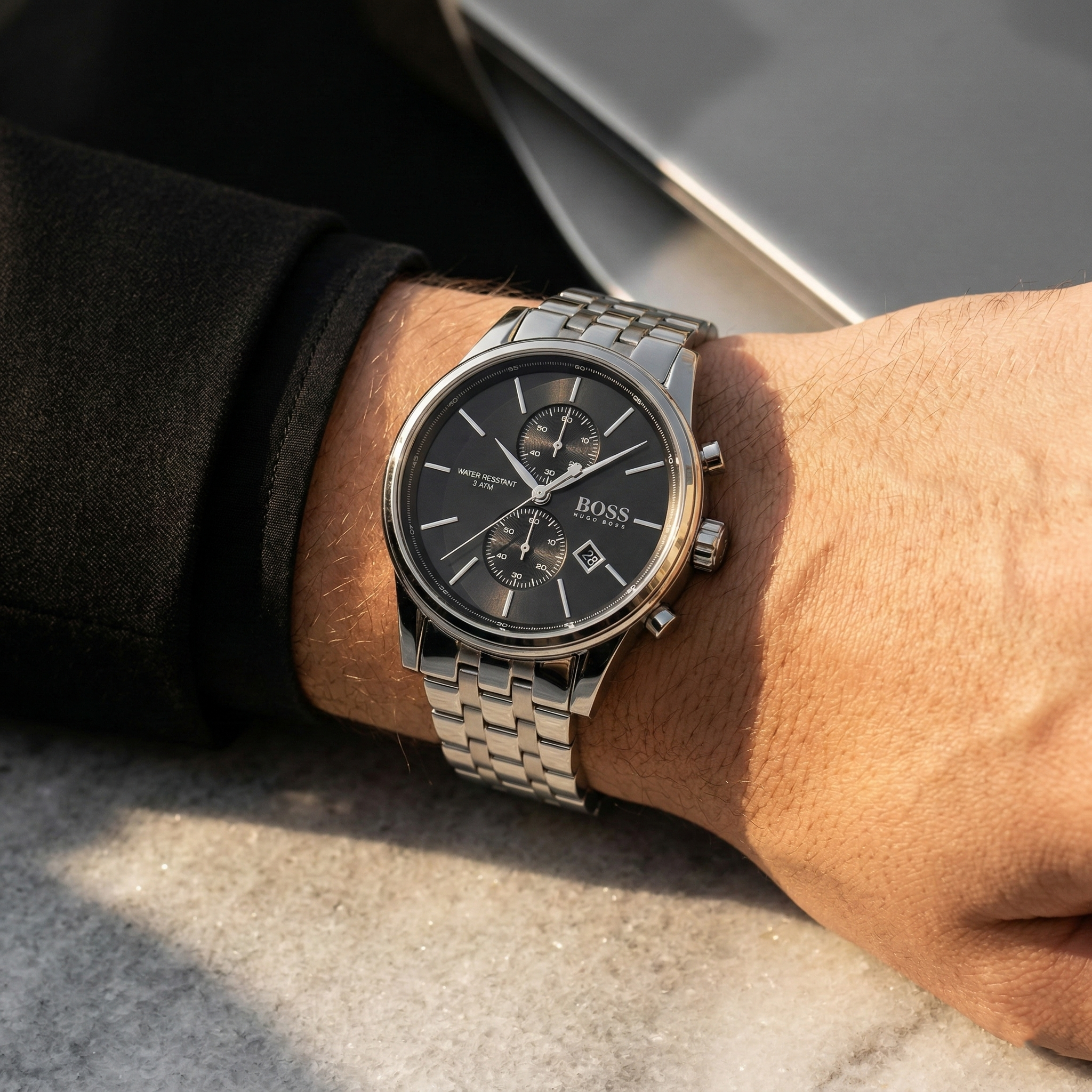 Close up of Hugo Boss Jet 1513383 on wrist showing black dial and silver metal strap with 50m water resistance