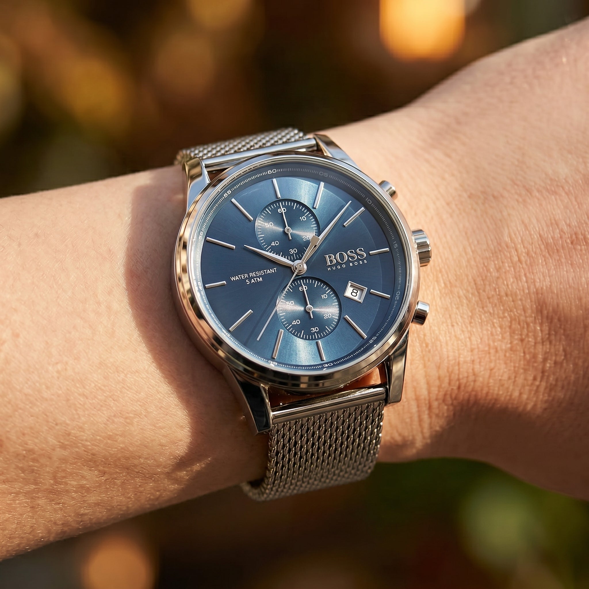 Close up shot of Boss Jet 1513441 on wrist showing the sleek silver case and blue sunray dial from Luxury Hub Store