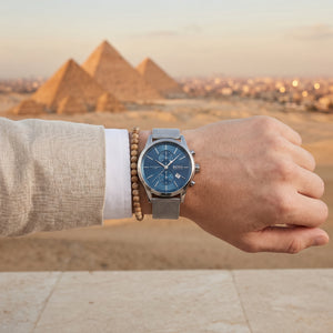 Lifestyle photo of Boss Jet 1513441 showing the elegant silver mesh watch on a man's wrist in a professional setting from Luxury Hub Store