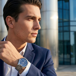 Professional man wearing Hugo Boss Governor 1513487 with blue textured dial and silver metal link strap water resistant 30m