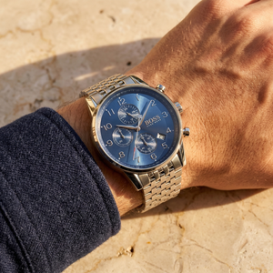 Close up of Hugo Boss Navigator 1513498 on wrist showing blue dial and silver metal link strap with 50m water resistance