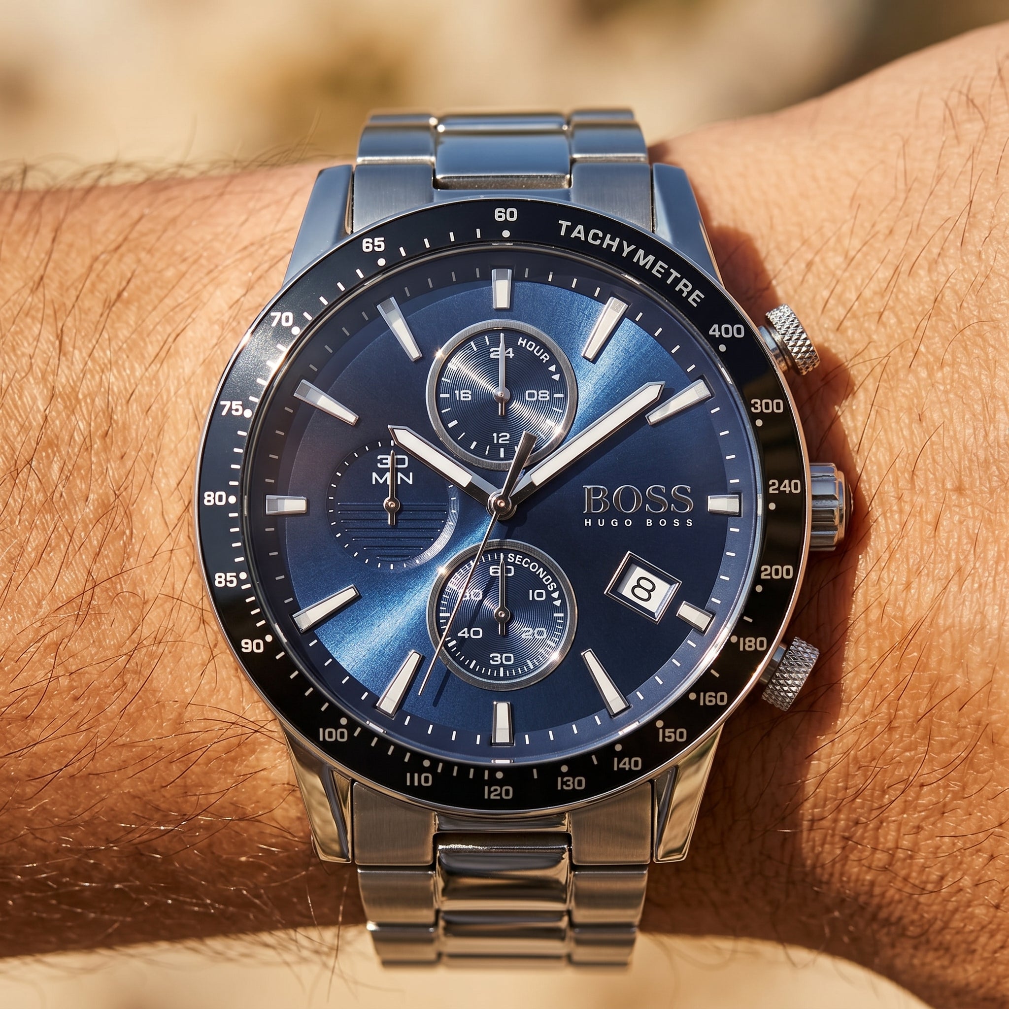 Close up shot of Boss Rafale 1513510 on wrist showing the polished silver case and blue sunray dial texture from Luxury Hub Store