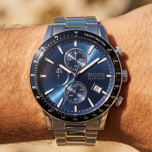 Close up shot of Boss Rafale 1513510 on wrist showing the polished silver case and blue sunray dial texture from Luxury Hub Store