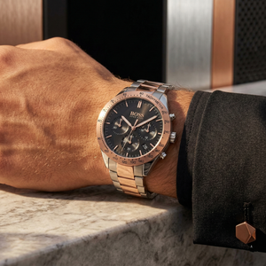 Close up of Hugo Boss Talent 1513584 on wrist showing black dial and two-tone metal strap with 50m water resistance