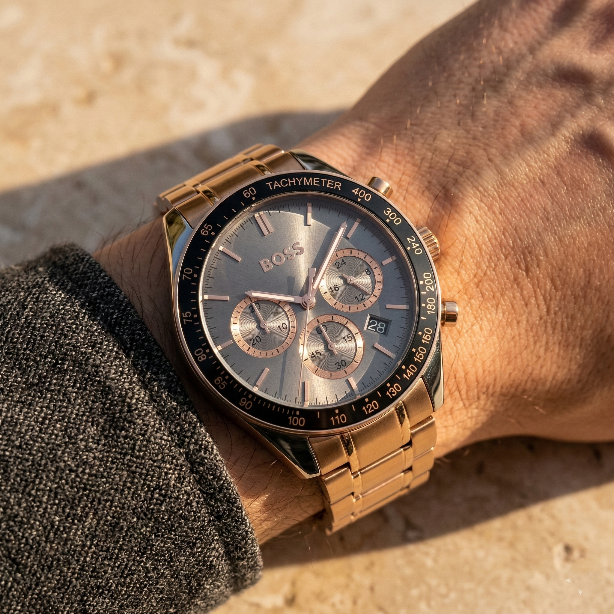 Close up of Hugo Boss Trophy 1513632 on wrist showing gray sunray dial and rose gold metal strap with 50m water resistance