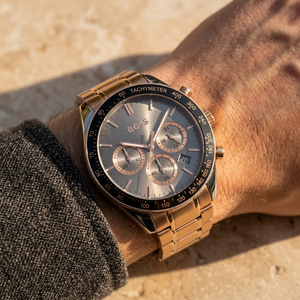 Close up of Hugo Boss Trophy 1513632 on wrist showing gray sunray dial and rose gold metal strap with 50m water resistance