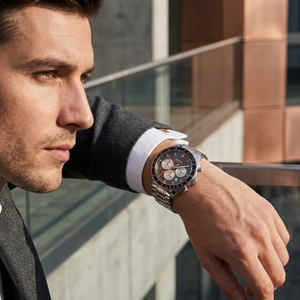 Professional man wearing Hugo Boss Trophy 1513634 with gray sunray dial and silver rose gold metal link strap water resistant 50m