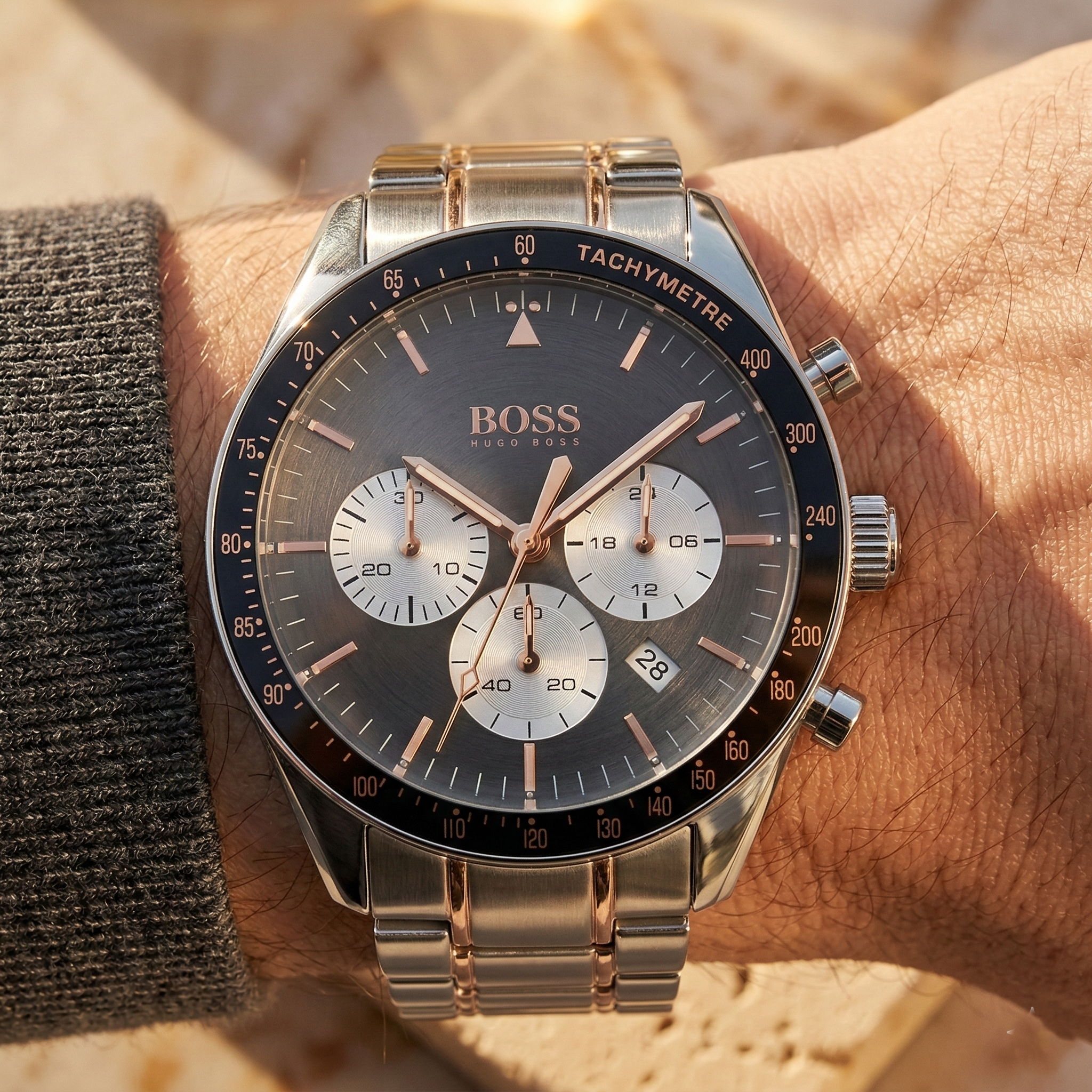 Close up of Hugo Boss Trophy 1513634 on wrist showing gray sunray dial and two-tone metal strap with 50m water resistance