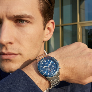 Professional man wearing Hugo Boss Intensity 1513665 with blue dial and silver metal link strap water resistant 50m