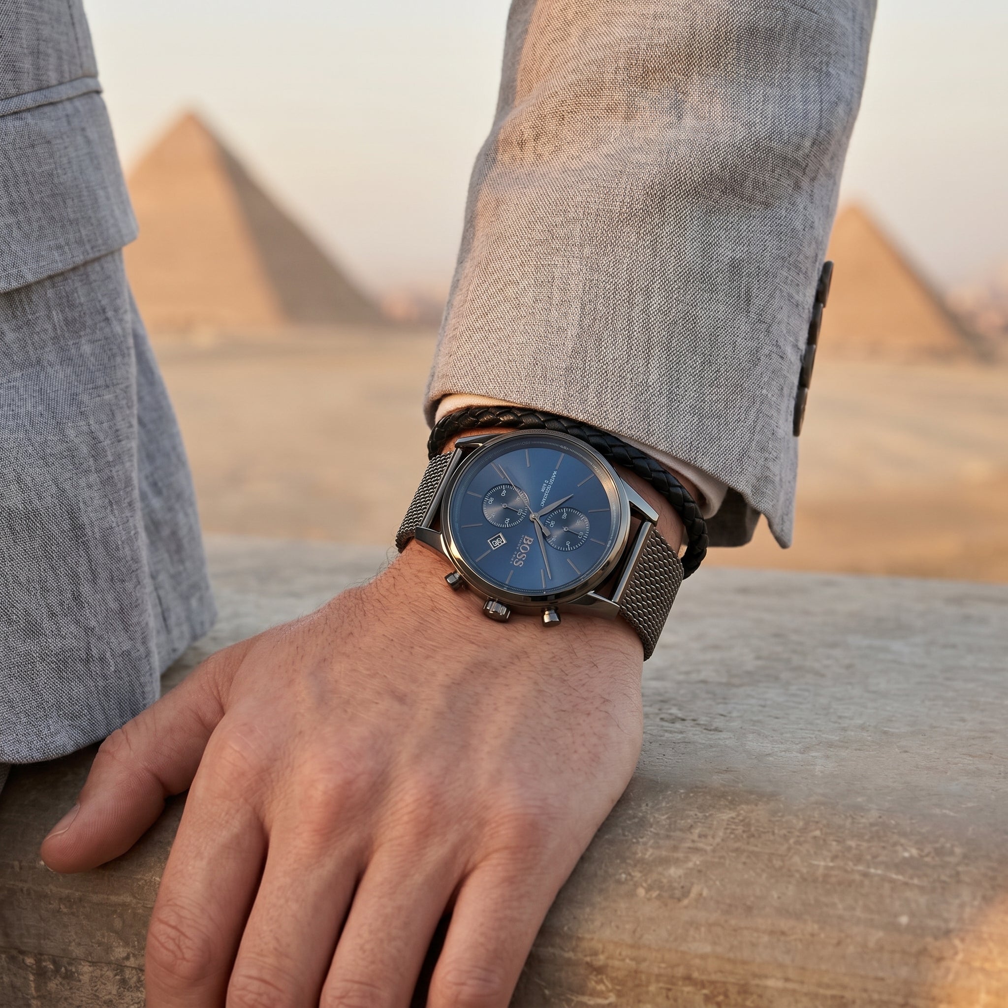 Lifestyle photo of Boss Jet 1513677 showing the bold silver watch on a man's wrist in a professional setting from Luxury Hub Store
